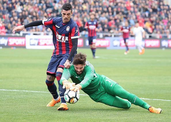 Roma's Brazilian goalkeeper Alisson (R) makes a save against...